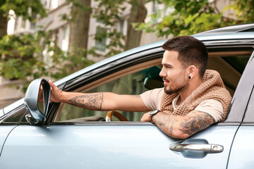 Canvas Print - Handsome man driving modern car