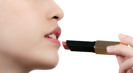 Wall Mural - Close up of asian woman holding or presenting lipstick isolated on white background.