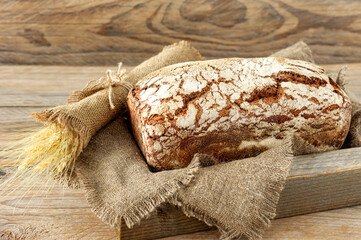 Wall Mural - freshly baked rye bread on burlap on rustic background. Homemade organic food