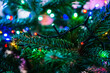 Closeup shot of a Christmas tree leaves decorated with led lights. Holidays mood