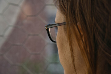 beautiful woman looking out the window melancholy on a rainy afternoon having a coffee or tea. bad weather depression concept