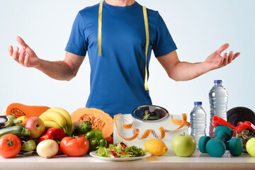 Wall Mural - Healthy food and sport accessories with scale and sportsman