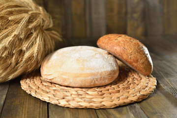 Fresh round breads on a wooden table