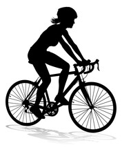 Bicyclist Riding Their Bike And Wearing A Safety Helmet In Silhouette