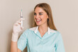 © inesbazdar - Portrait of medical nurse holding injection.