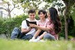 © Basicdog - Happy family relaxes in the front lawn on a weekend together.