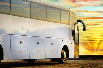 Wall Mural - white coach bus waiting for passengers in the morning, beautiful sunrise background.