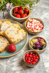 Canvas Print - front view yummy cake slices with strawberries on a light background fruit sweet cake pie