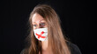 
Battered woman, black eye, white mask with a red adhesive tape cross, symbol of forced silence. S.O.S Message