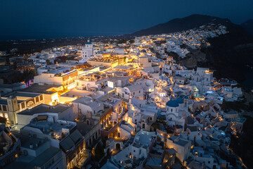 Wall Mural - Oia town on Thira. Santorini island with colorful volcanic cliffs and deep blue sea aerial view