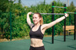 © Ivan Karpov - Training on the street, a young female athlete makes a workout on the street platform. Female athlete warms up before training on a treadmill, stretching on a rubber stadium