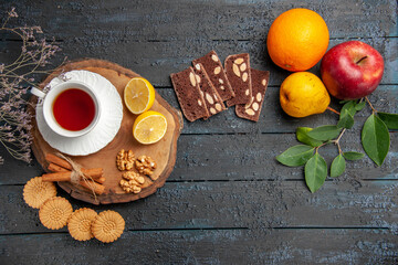 top view cup of tea with fruits and sweets on dark background photo ceremony sweet