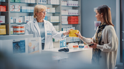 Wall Mural - Pharmacy Drugstore Checkout Cashier Counter: Portrait of Pharmacist and a Woman Using NFC Smartphone with Contactless Payment Terminal to Buy Prescription Medicine, Vitamins, Health Care Products