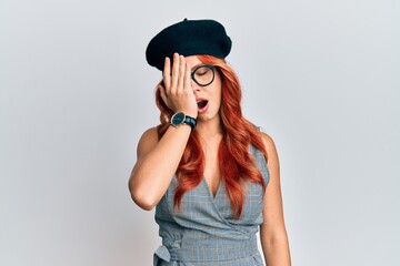 Wall Mural - Young redhead woman wearing fashion french look with beret yawning tired covering half face, eye and mouth with hand. face hurts in pain.