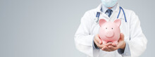 Doctor Holding Piggy Bank. Health Insurance