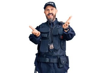 Wall Mural - Young handsome man wearing police uniform smiling cheerful offering hands giving assistance and acceptance.