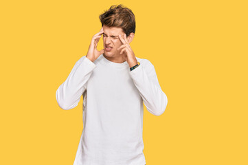 Handsome caucasian man wearing casual white sweater with hand on head, headache because stress. suffering migraine.