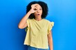 © Krakenimages.com - Young african american girl wearing casual clothes doing ok gesture shocked with surprised face, eye looking through fingers. unbelieving expression.