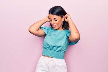 Poster - Young beautiful brunette woman smiling happy and confident. Standing with smile on face over isolated pink background