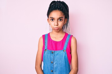 Canvas Print - Young african american girl child with braids wearing casual clothes over pink background depressed and worry for distress, crying angry and afraid. sad expression.