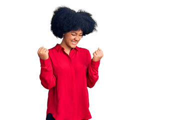 Sticker - Young african american girl wearing casual clothes very happy and excited doing winner gesture with arms raised, smiling and screaming for success. celebration concept.