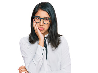 Beautiful asian young woman wearing business shirt and glasses thinking looking tired and bored with depression problems with crossed arms.