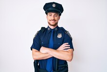 Young Caucasian Man Wearing Police Uniform Happy Face Smiling With Crossed Arms Looking At The Camera. Positive Person.
