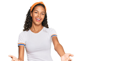 Poster - Young african american girl wearing casual clothes smiling cheerful offering hands giving assistance and acceptance.