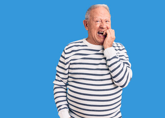 Canvas Print - Senior handsome grey-haired man wearing casual striped sweater looking stressed and nervous with hands on mouth biting nails. anxiety problem.