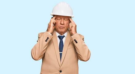 Poster - Senior caucasian man wearing architect hardhat suffering from headache desperate and stressed because pain and migraine. hands on head.