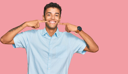 Poster - Young handsome african american man wearing casual clothes smiling cheerful showing and pointing with fingers teeth and mouth. dental health concept.