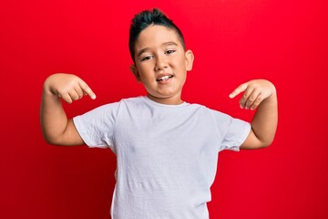 Sticker - Little boy hispanic kid wearing casual white tshirt looking confident with smile on face, pointing oneself with fingers proud and happy.