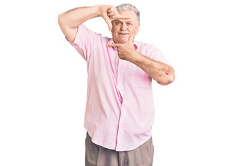 Canvas Print - Senior grey-haired man wearing casual clothes smiling making frame with hands and fingers with happy face. creativity and photography concept.