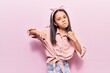 © Krakenimages.com - Beautiful child girl wearing casual clothes punching fist to fight, aggressive and angry attack, threat and violence