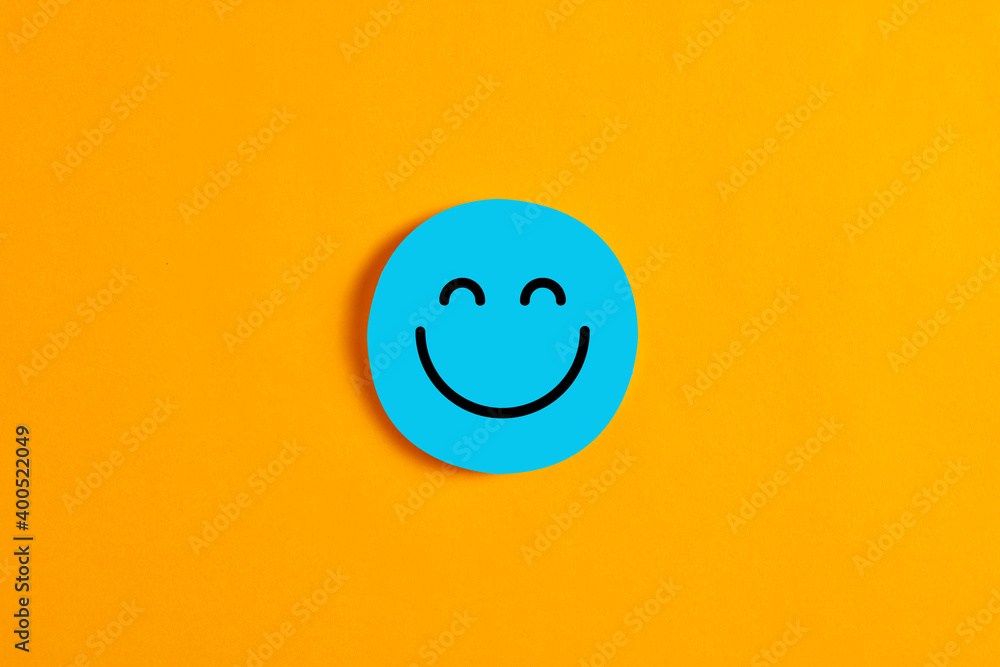 Blue round circle with a happy or smiley face icon on it against yellow background.