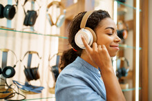 Woman Trying On Headphones In Acoustics Store