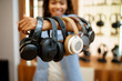 © Nomad_Soul - Woman shows headphones collection in audio store