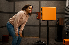 Woman Choosing Acoustics In Speaker System Store
