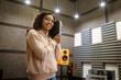 © Nomad_Soul - Smiling woman holds sound speaker in store