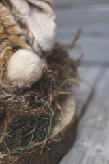   nest of flowers with a rabbit on wooden background 