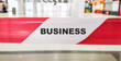 © realone952 - The word BUSINESS on a red ribbon on the background of the store.