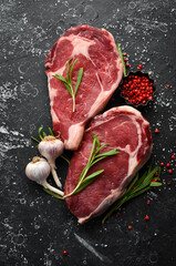 Wall Mural - Raw meat, beef steak on dark background. Top view. Free space for your text.