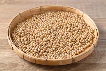 Soybeans seed in a bamboo tray on wooden background