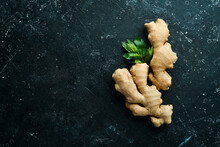 Fresh Ginger Root On A Black Stone Background. Top View. Rustic Style.