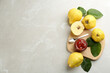 Delicious quince jam and fruits on light grey marble table, flat lay. Space for text