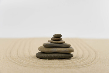 Zen sand garden meditation stone background with copy space. Stones and lines drawing in sand for relaxation. Concept of harmony, balance and meditation, spa, massage, relax. Set Sail Champagne color