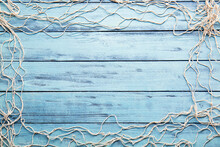 Frame Made Of Fish Net On Color Wooden Background