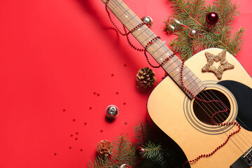 Guitar with Christmas decor on color background