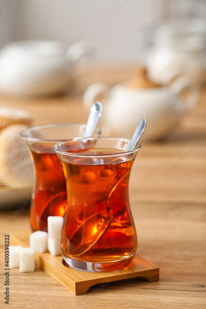 Cups of hot Turkish tea on wooden table