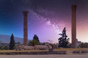 two columns of the Olympian Zeus ancient temple illuminated by starry night sky, Athens Greece